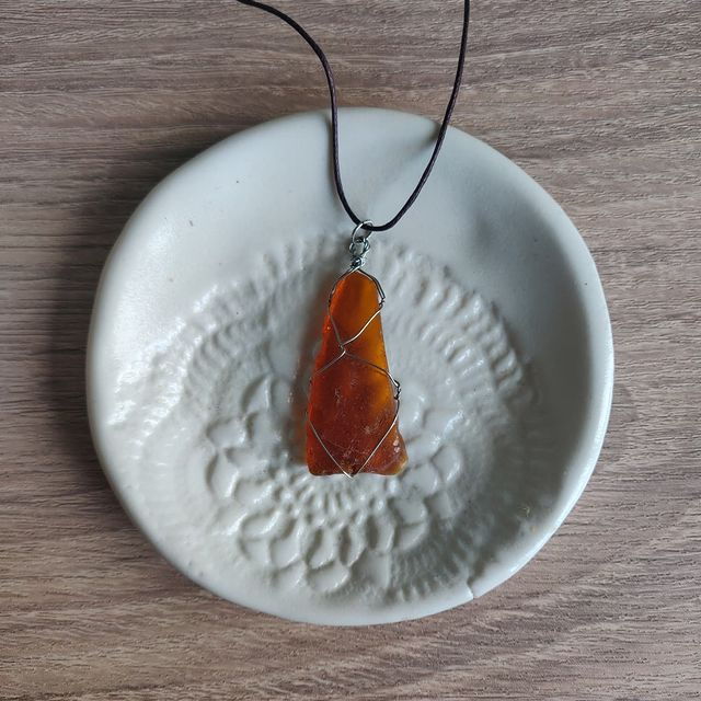 Amber sea glass with silver wire wrap. $15