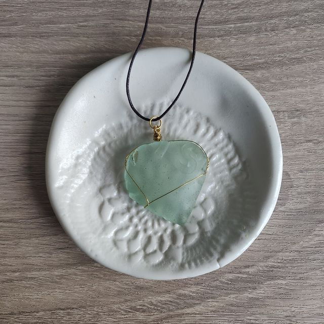 Light blue sea glass with gold wrap. $18. This piece is super cool, you can still see some lettering!